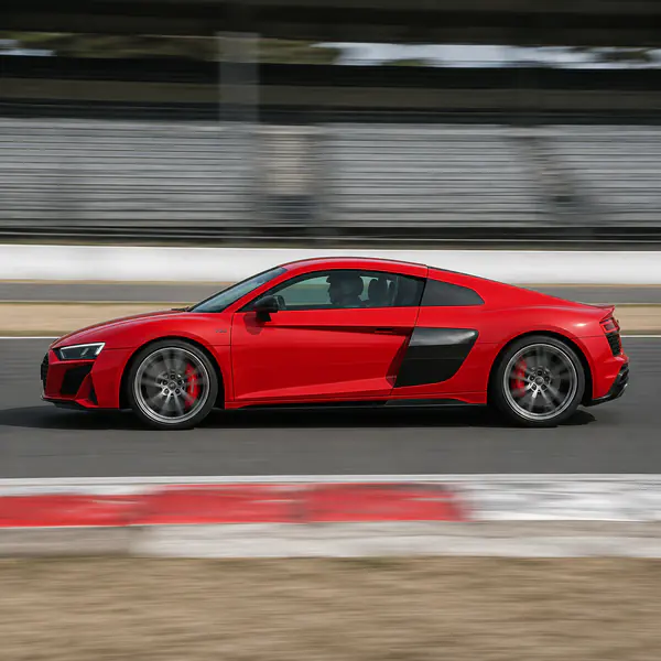 Panning Shot — The camera pivots with a passing car during a slower exposure, producing a sharp subject against directional blur