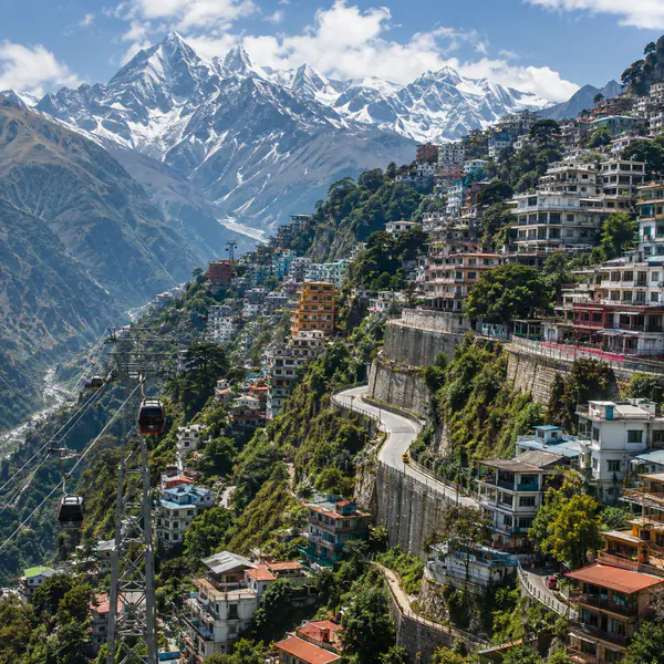 Mountain City — Follows steep terrain with terraced neighborhoods, winding roads, retaining walls, and elevated views